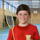 A kid holding a badminton racket
